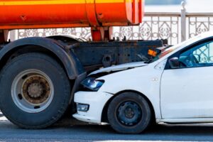 Car collides with truck at truck stop